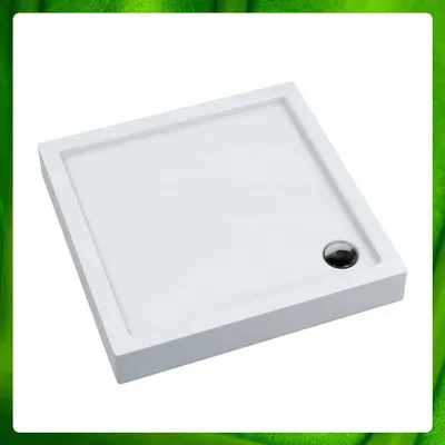 A white square shower tray with a chrome drain is shown against a white background with a green border.