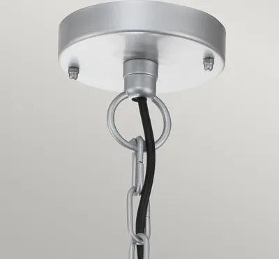 Close-up of a silver-colored ceiling mount for a pendant light, showing the chain and electrical cord.