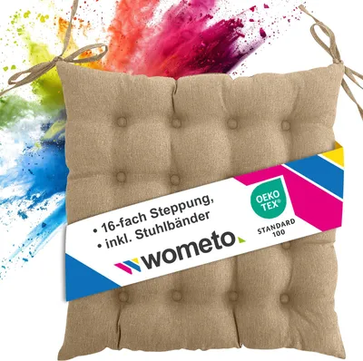 A beige seat cushion with ties, placed against a background of colorful powder explosions.