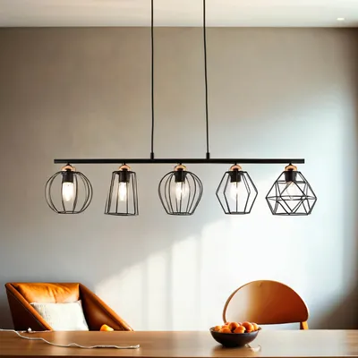 A linear pendant light fixture with five geometric metal shades hangs above a wooden dining table.