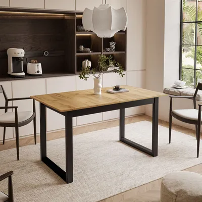 A dining room scene with a table and chairs, set against a modern kitchen backdrop.