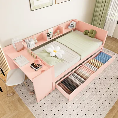 A pink Jugendbett (youth bed) with integrated desk and storage drawers, shown in a bedroom setting.