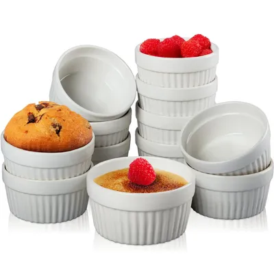 A collection of white ceramic ramekins, some filled with food items like a muffin and creme brulee, and others empty.