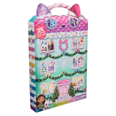 A cardboard advent calendar shaped like a dollhouse, decorated for Christmas.