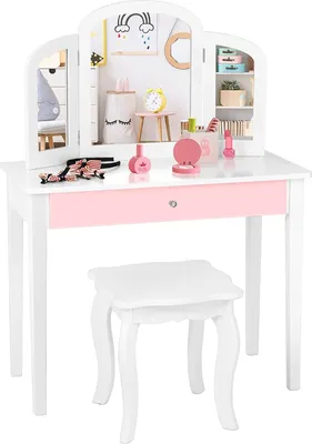 A child's vanity table and stool set with a tri-fold mirror and accessories.