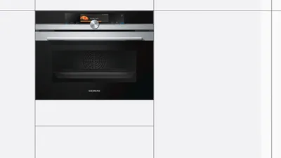A built-in Siemens oven is shown in a modern kitchen setting.