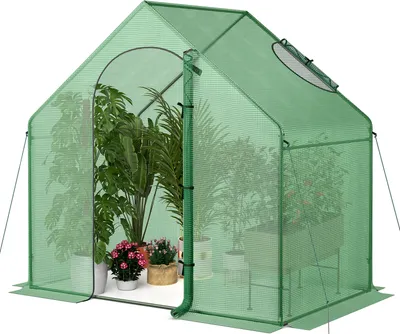 A green greenhouse filled with various potted plants.