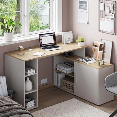 A home office corner with a desk, laptop, and decorative items.
