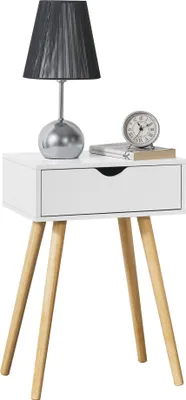 A white bedside table with a drawer, a lamp, and a clock on top, set against a white background.