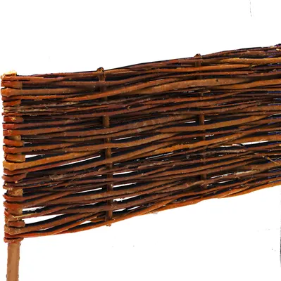 A close-up view of a woven willow border for a garden bed.