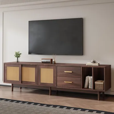 A modern living room setting with a TV mounted on the wall above a wooden media console.