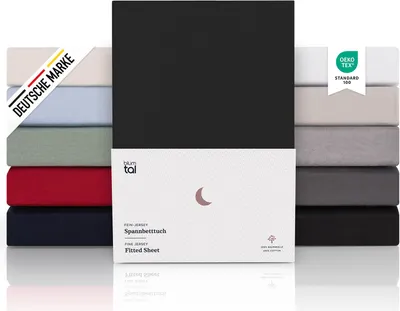 A stack of folded fitted sheets in various colors, with a product box in the foreground.