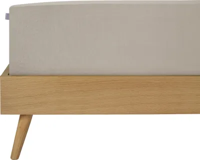 A close-up view of a bed frame with a fitted sheet.