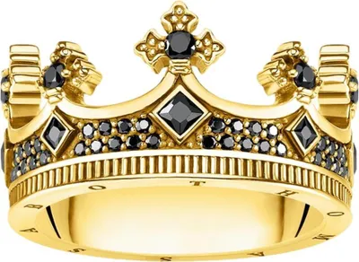 A close-up studio shot of a gold ring designed to look like a crown, adorned with black stones.