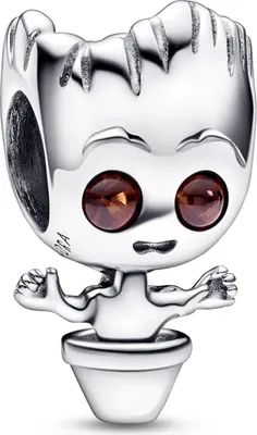 A close-up studio shot of a silver charm shaped like Baby Groot from Guardians of the Galaxy, sitting in a pot. The charm has two brown gemstone eyes and outstretched arms.