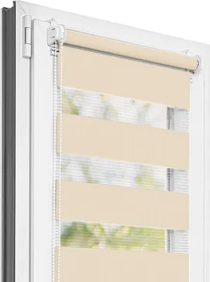A close-up view of a beige roller blind installed on a window frame.