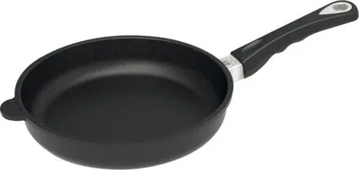 A black frying pan with a black handle is shown against a white background.