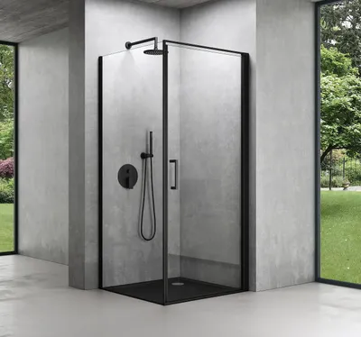 A modern bathroom with a black framed glass shower enclosure.