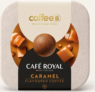 A close-up of coffee packaging with caramel pieces and a coffee ball.