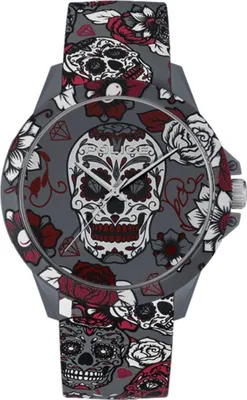 A close-up, front-facing view of a watch with a skull and floral pattern.