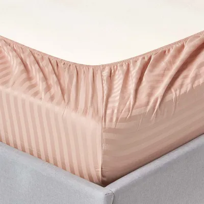 Close-up of a fitted sheet on a bed.