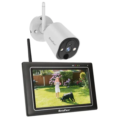 A security camera and its monitor are displayed against a white background. The monitor shows a live feed of a child and a dog in a garden.