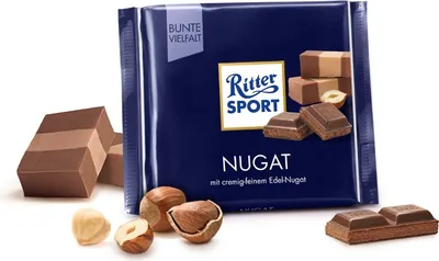 A Ritter Sport Nougat chocolate bar package with loose hazelnuts and pieces of chocolate.