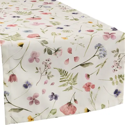 A close-up, diagonal view of a table runner with a floral print.