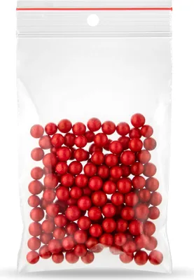 A clear plastic bag filled with small red balls.