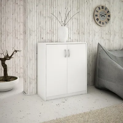 A white cabinet with two doors is shown in a room with a textured wall and a large beanbag chair.