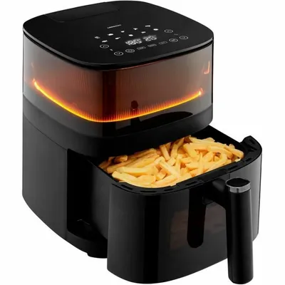 A black air fryer filled with french fries, with the heating element glowing orange.