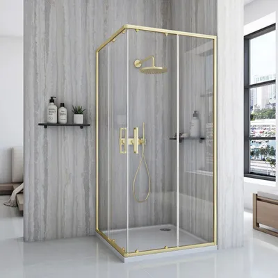 A modern bathroom with a gold-framed glass shower enclosure.