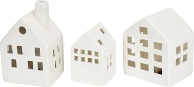 Three white ceramic houses with cut-out windows and doors, arranged side-by-side.
