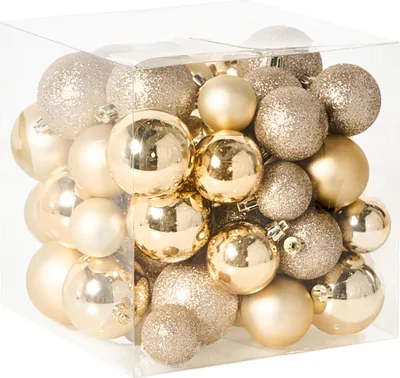 A clear, well-lit studio shot of a clear plastic cube filled with gold Christmas ornaments.