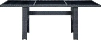 A dark gray poly rattan garden table with a glass top, shown from the front on a white background.