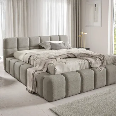 A modern bedroom with a large upholstered bed.