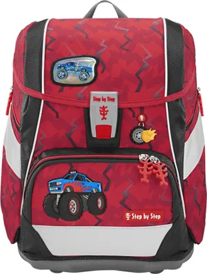 A red backpack with monster truck graphics and accessories.
