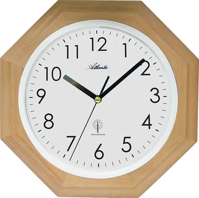 A close-up, front-facing view of an octagonal wall clock with a wooden frame and a white face.
