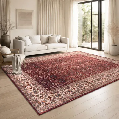 A living room with a sofa and a rug.