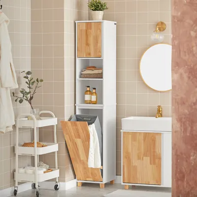 A bathroom scene with a tall cabinet, a vanity, and a rolling cart.