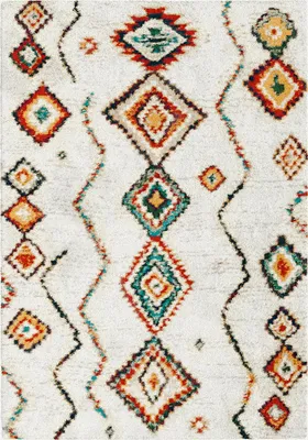 A close-up, top-down view of a shaggy rug with a Berber-style geometric pattern.
