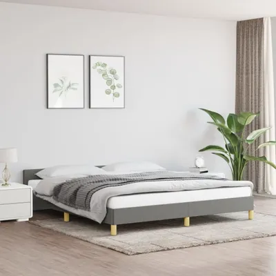 A bedroom scene with a bed, nightstand, and artwork.