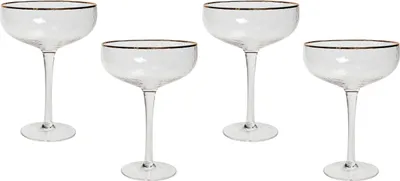 Four champagne glasses with gold rims are arranged on a white background.