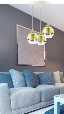 A modern living room with a gray sofa and a contemporary chandelier.