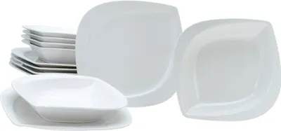A collection of white ceramic plates and bowls stacked and arranged on a white background.