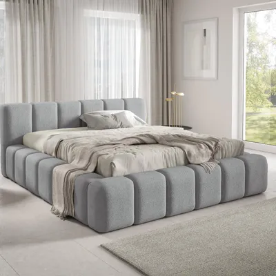 A modern bedroom with a large upholstered bed.