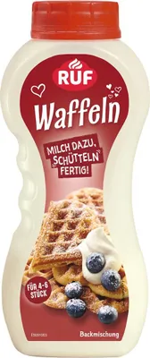 A bottle of waffle mix with a picture of waffles and blueberries on it.