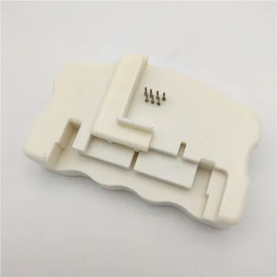 A white plastic chip resetter for Epson printer cartridges is shown on a white background.