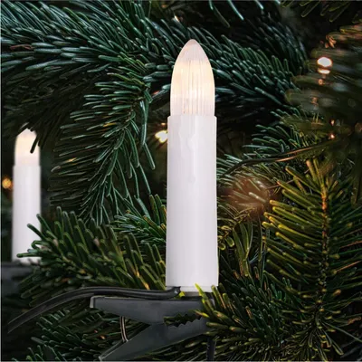 Close-up of LED candle lights clipped onto a Christmas tree.