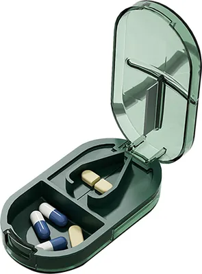 A pill cutter and storage box with pills inside.